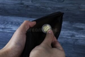 maos segurando carteira e moedas brilhantes