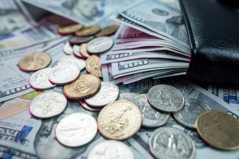 moeda e carteira com notas espalhadas