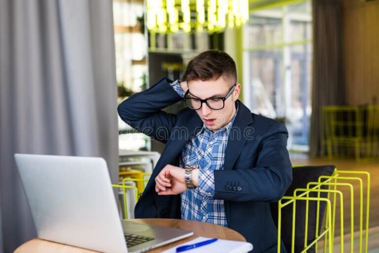 Falta Não Justificada Configura Justa Causa no Trabalho 7 trabalhador preocupado olhando relogio no escritorio